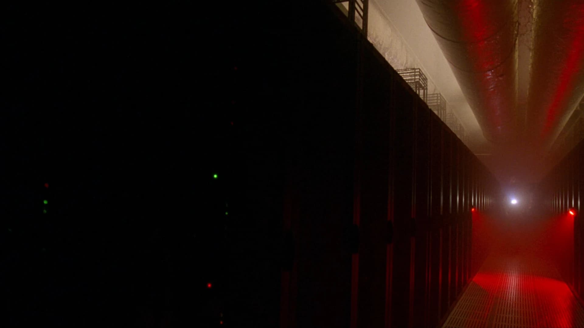 Editorial illustration of a dark server aisle under red emergency lighting