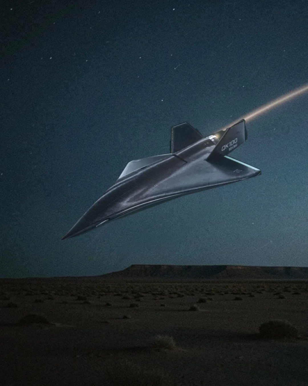 QK-100 in flight over an open desert field at dusk