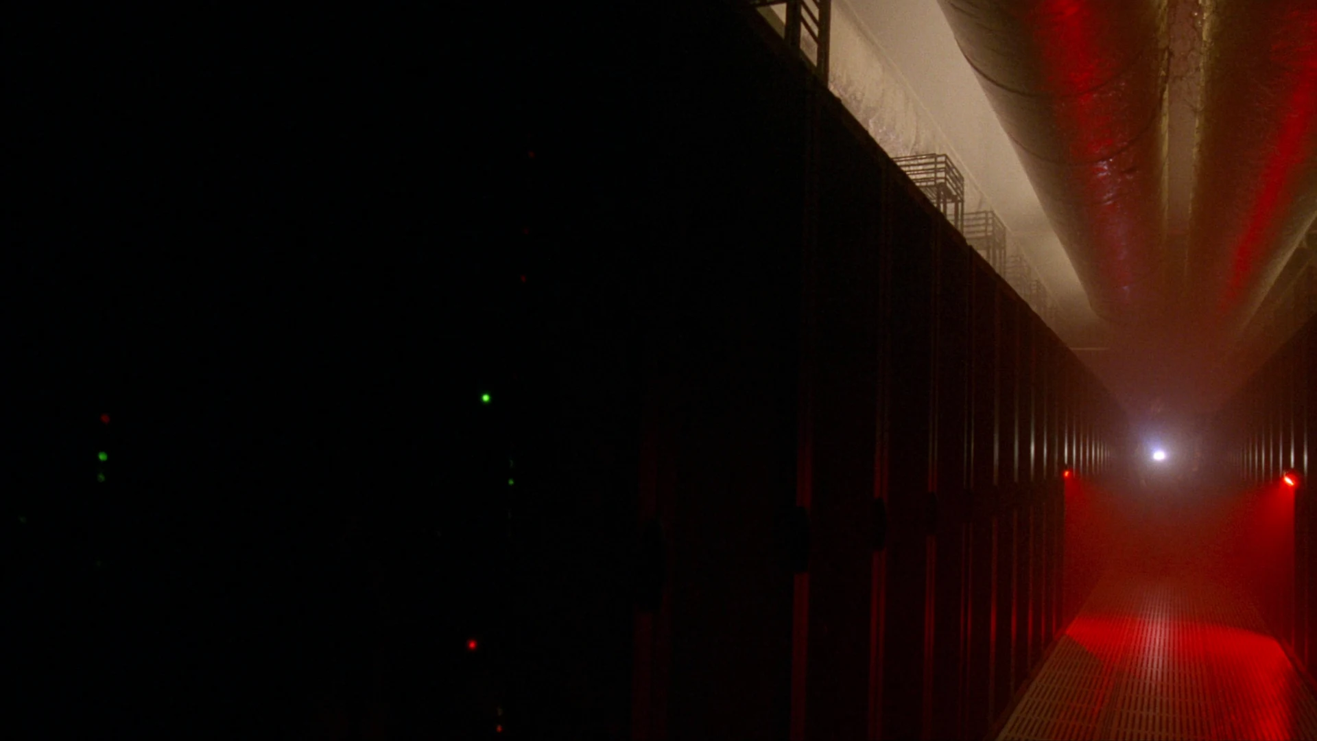 Editorial illustration of a dark server aisle under red emergency lighting